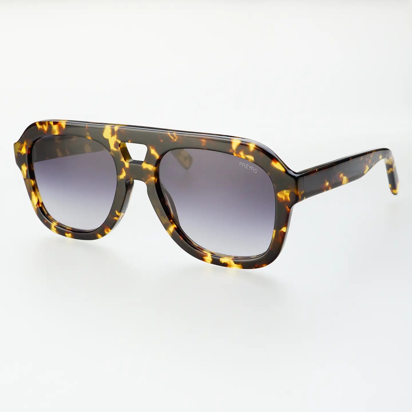 Yellow tortoise sunglasses against a white background. 