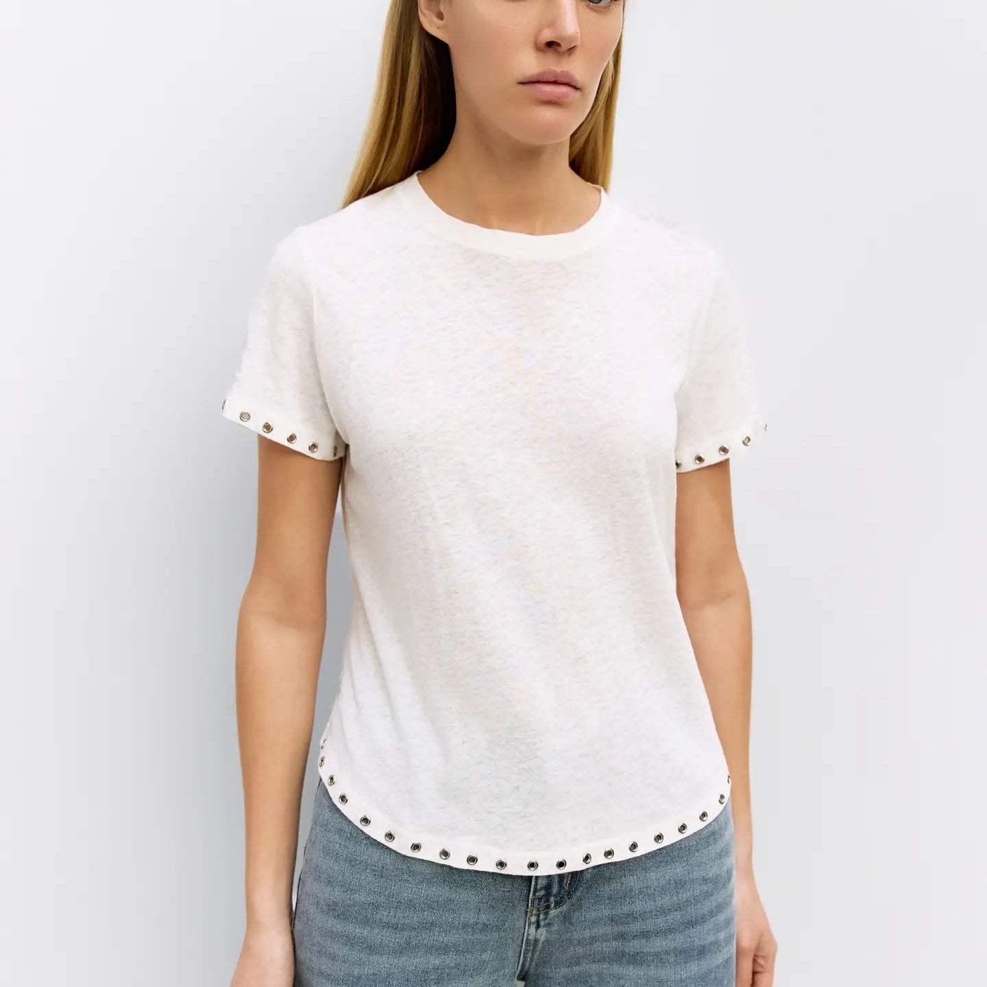 Cream linen short-sleeve Zoey top with studded trim detail on sleeves and hemline, styled with blue jeans Main image